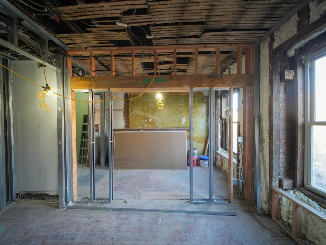 A three-story brownstone stands in mid-transformation, captured at the raw and honest “before” stage of a full interior renovation. These images document a moment that usually disappears once the walls are closed and the finishes are installed — exposed framing, stripped ceilings, rough staircases, and open corridors that reveal the building’s original structure and hidden history. Light spills in through skylights and tall windows, cutting through layers of dust and unfinished surfaces, creating a quiet contrast between decay and renewal. The space feels both industrial and intimate: narrow